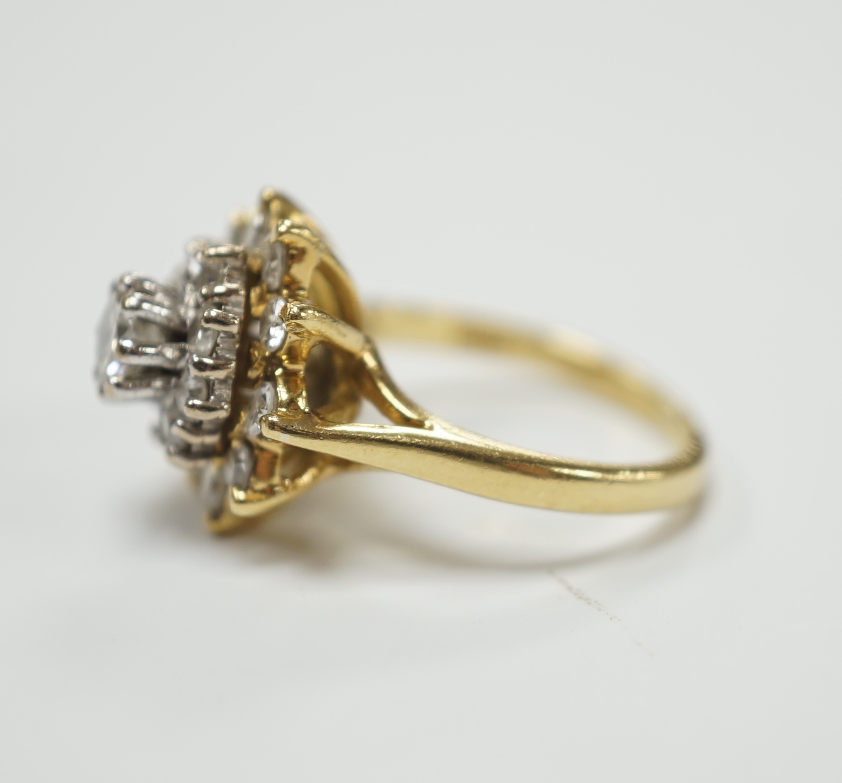 An 18ct and diamond cluster set dress ring, size I, gross weight 5.8 grams